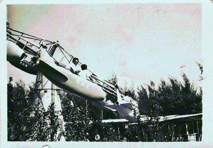 Two men riding an airplane-themed rollercoaster